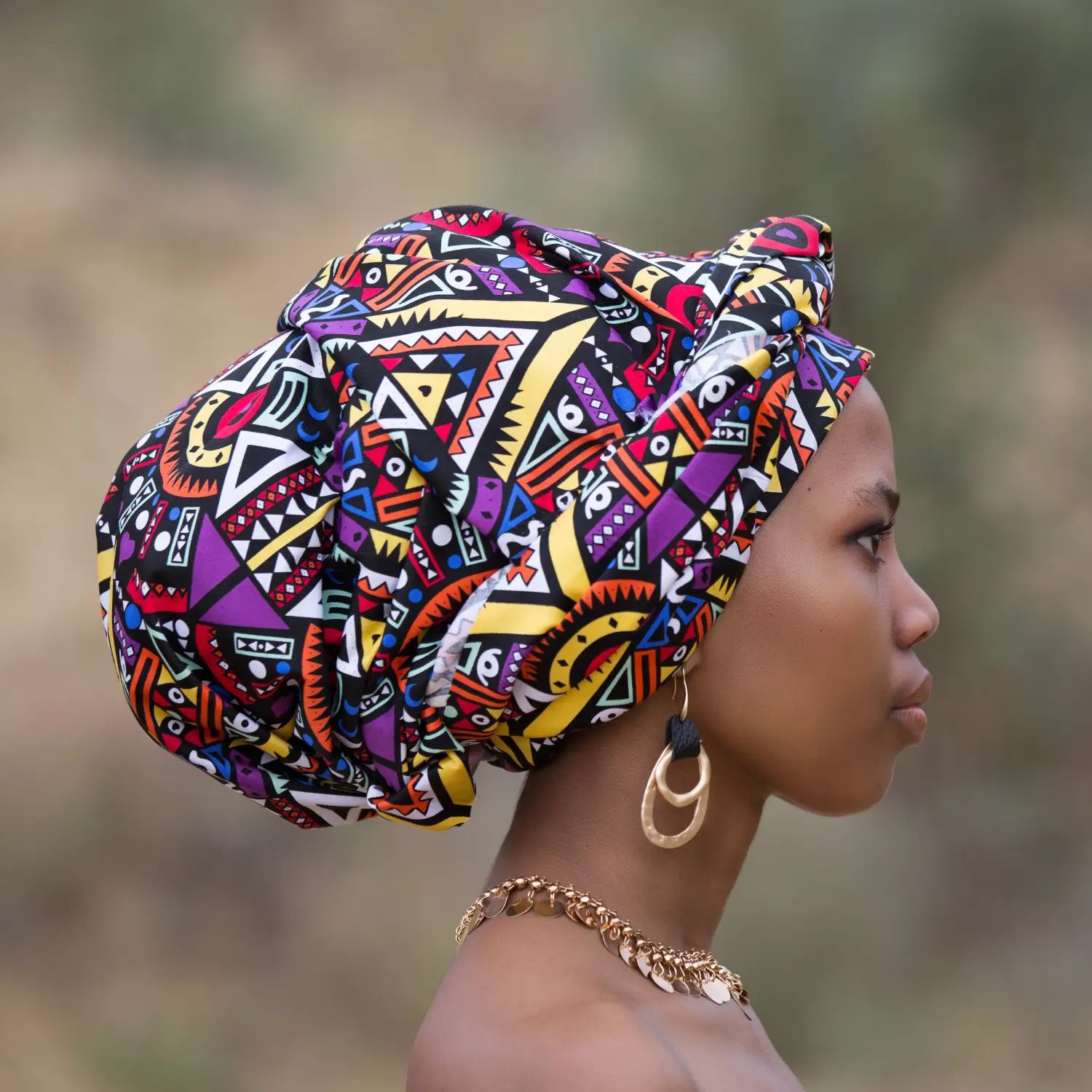 A woman wearing a traditional African head dressing.