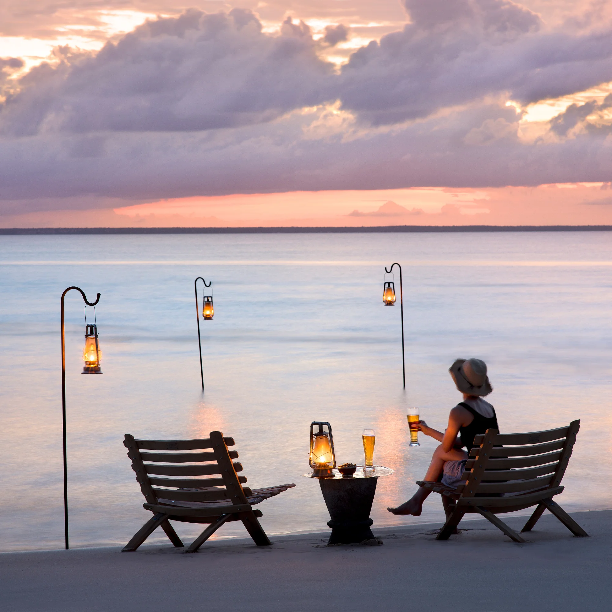 Beach chairs on the sandy beaches of Mozambique at sunset